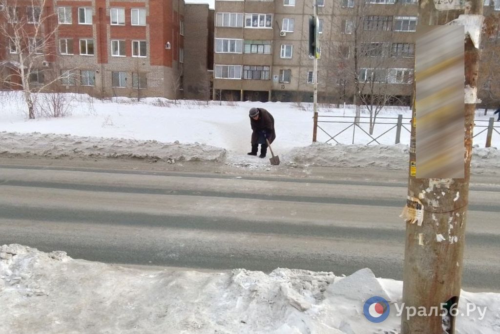 Пенсионерка очищает переход около поликлиники в Орске. 17.01.2024