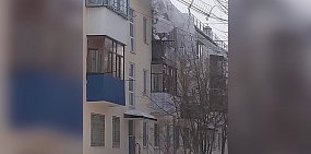 С крыши дома в Гае сошла лавина снега. Над подъездом повисло металлическое ограждение (видео)